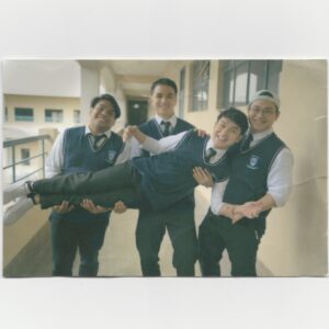 The three friends carry The Protagonist for a silly photo.